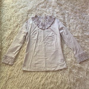 Dainty Jewell’s ruffle collar and long sleeve top